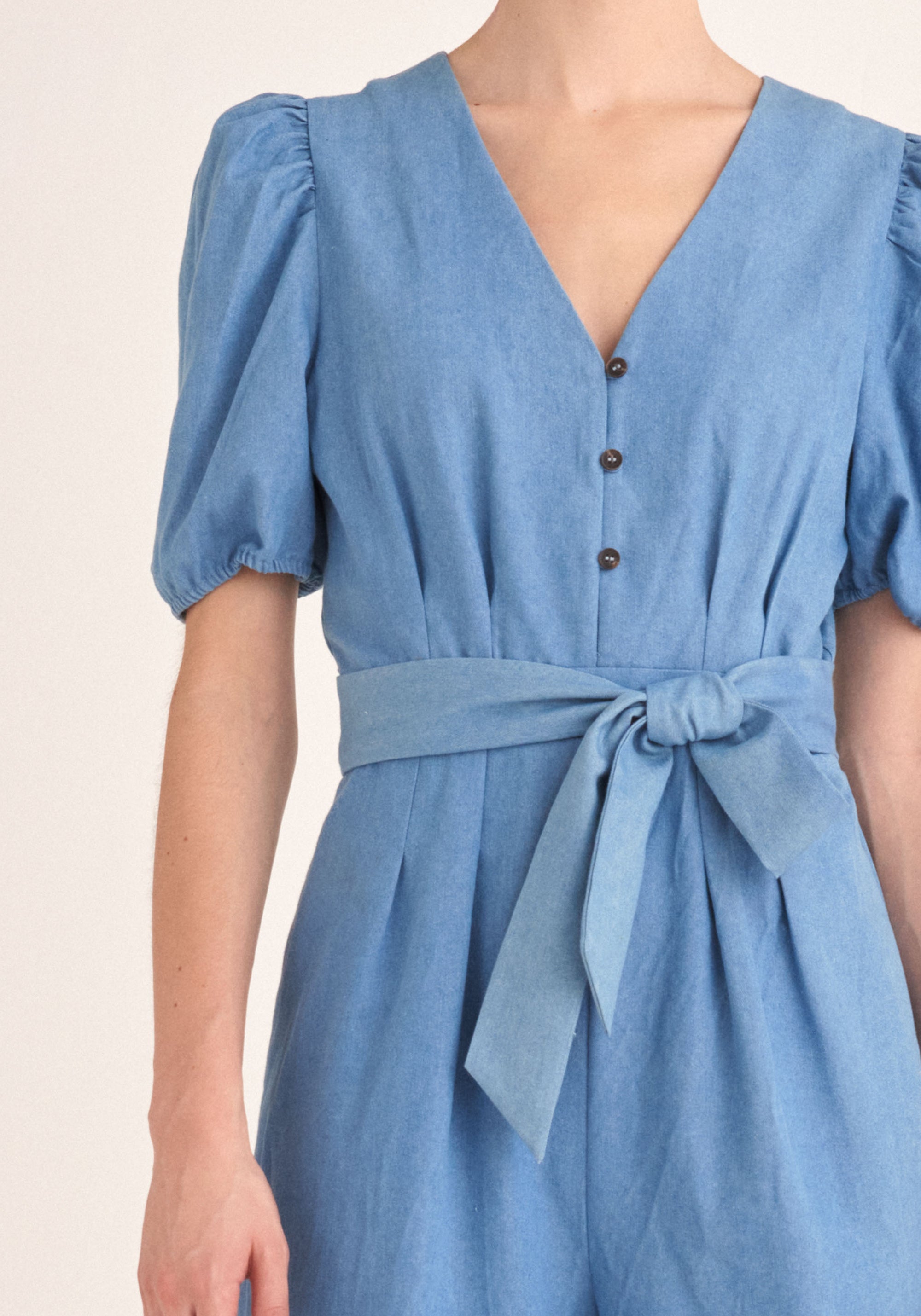 Paisie Puff Sleeve Denim Jumpsuit with Belt in Light Blue Close Up