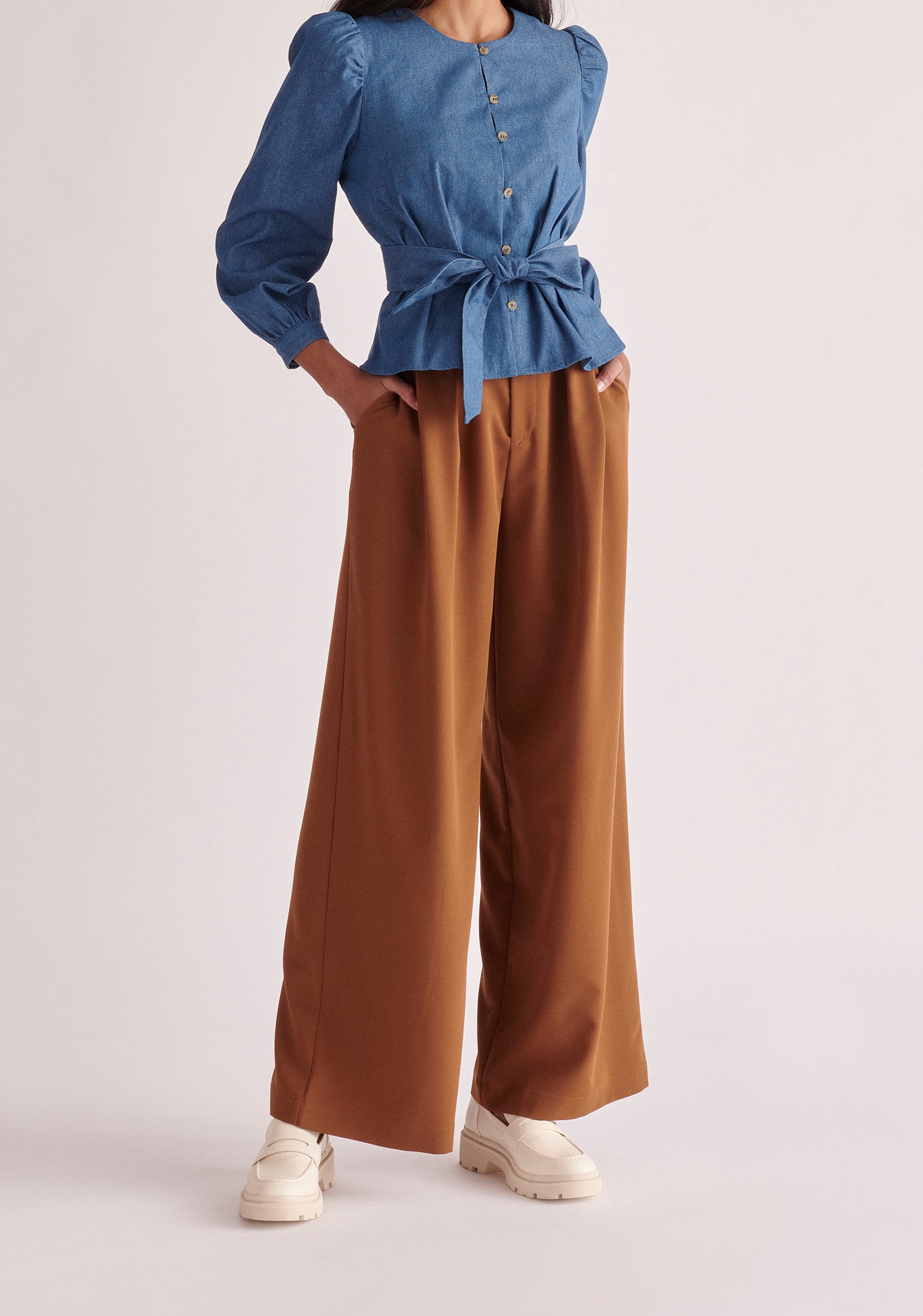 Paisie Long Sleeve Belted Denim Blouse in Light Blue 