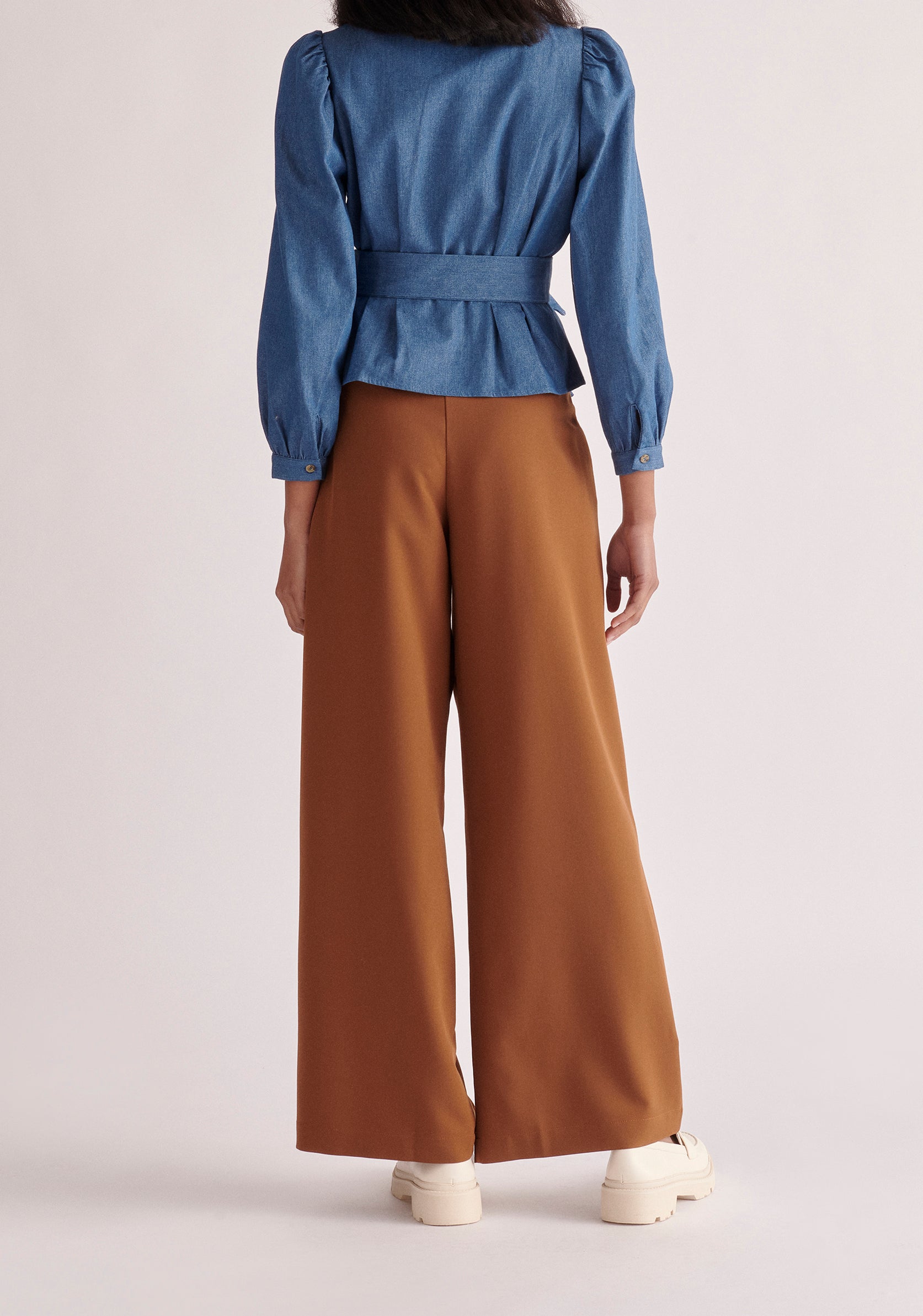 Paisie Long Sleeve Belted Denim Blouse in Light Blue Back