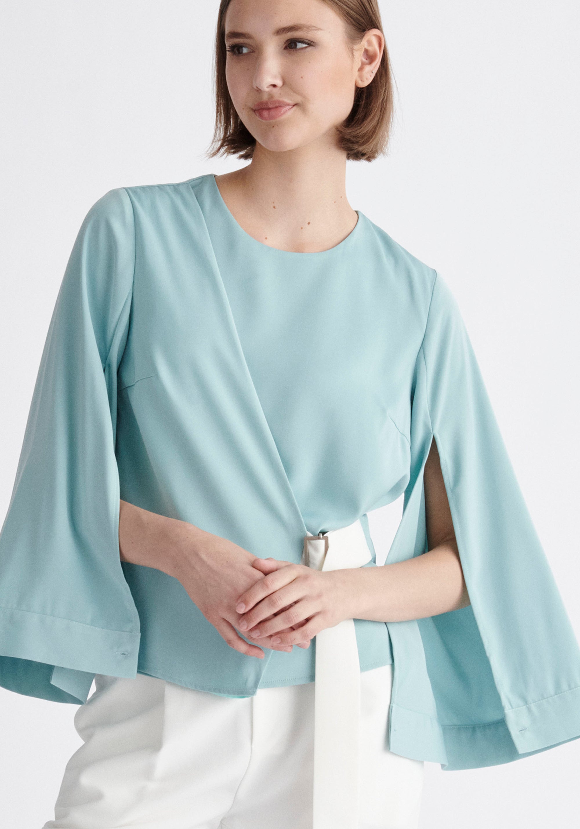 Paisie Wrap Top with Cape Sleeves in Light Teal and White Close Up