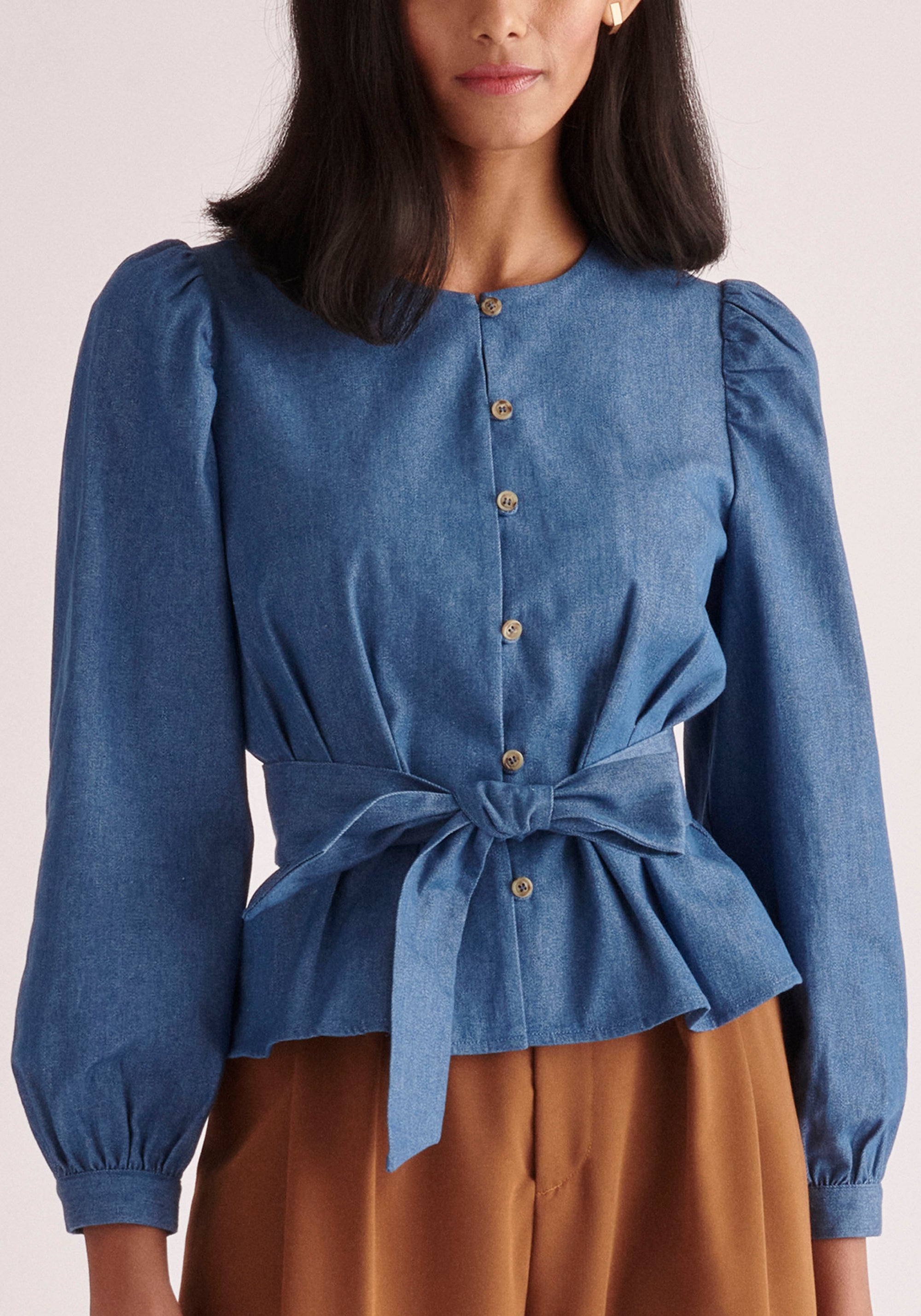 Paisie Long Sleeve Belted Denim Blouse in Light Blue Close Up
